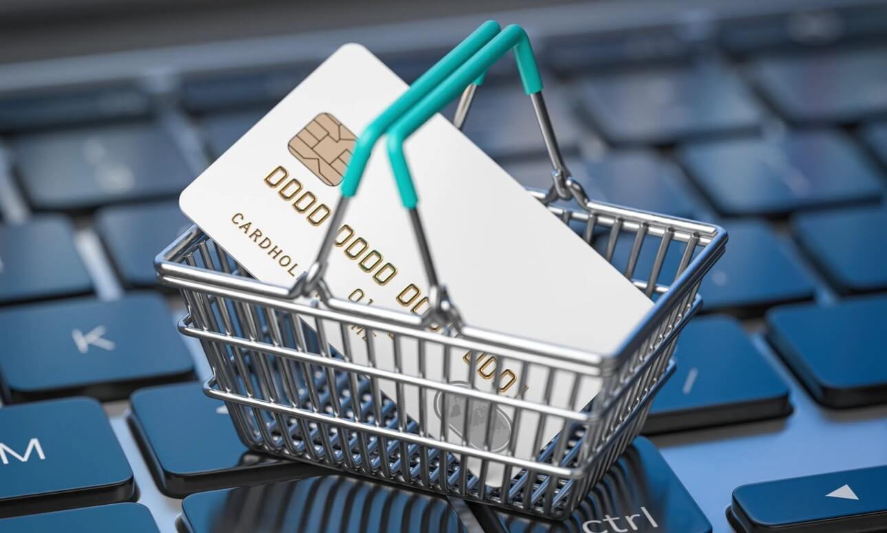 Credit card in small shopping basket on laptop keyboard for top shopify apps to improve conversion rate