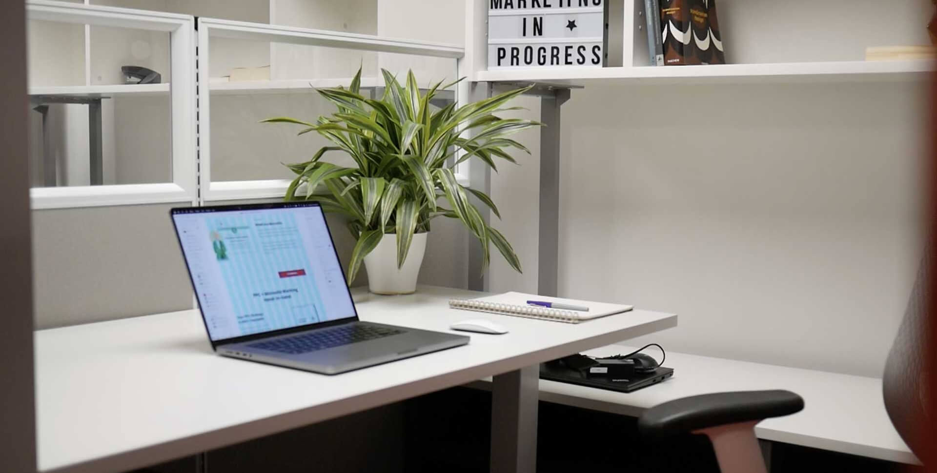 Open laptop on ready artwork digital marketing agency los angeles monrovia office cubicle