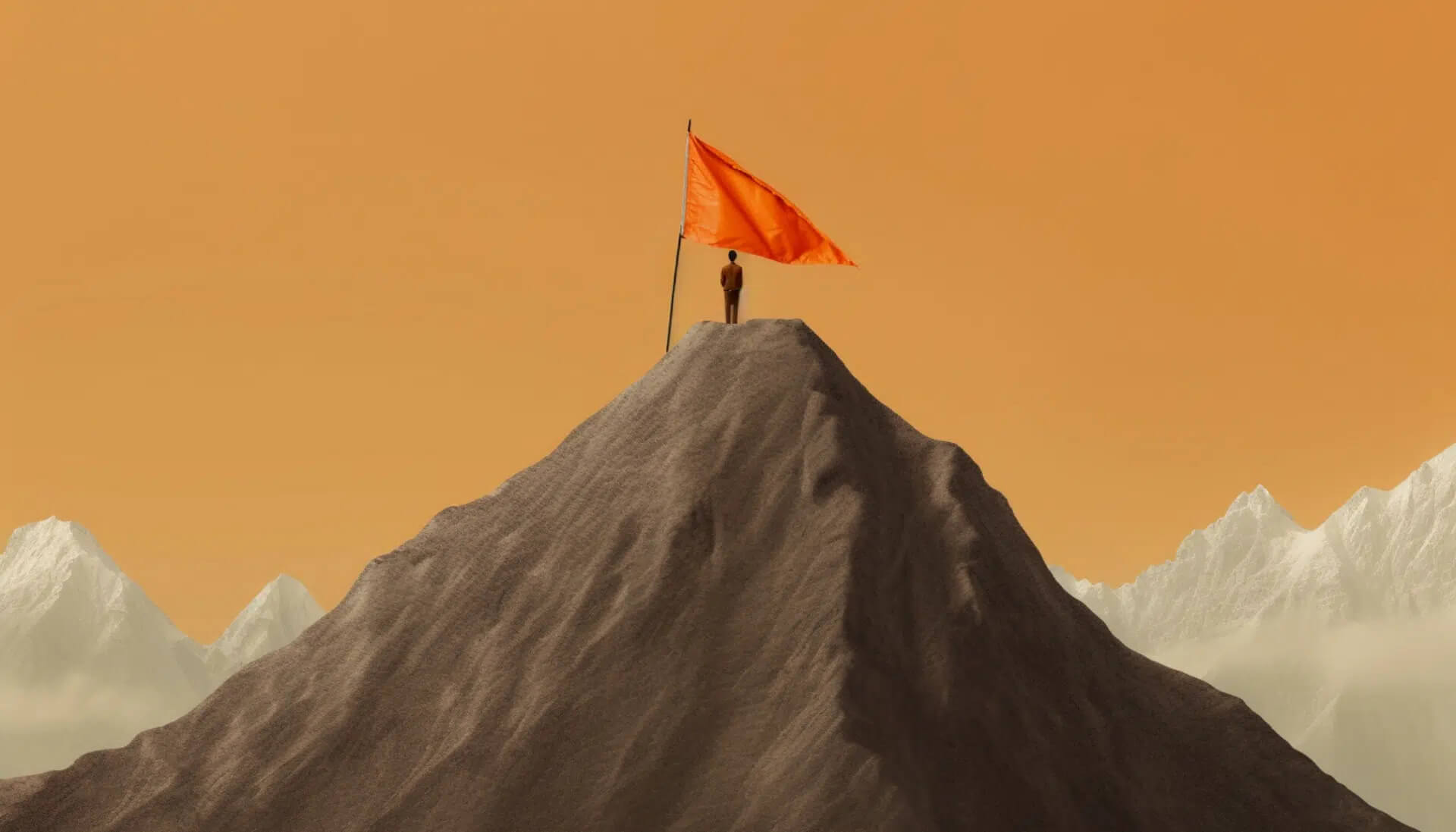 Person standing on top of mountain with orange flag on summit to mark success
